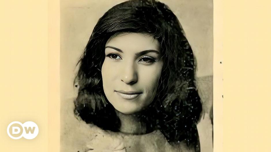 A black and white photo of a woman with long hair.