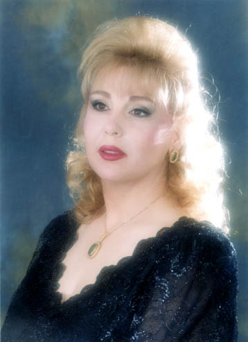 A woman with blonde hair and wearing black.