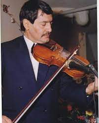 A man in a suit and tie playing the violin.
